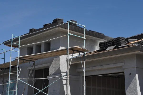 Residential roofing construction with scaffolding