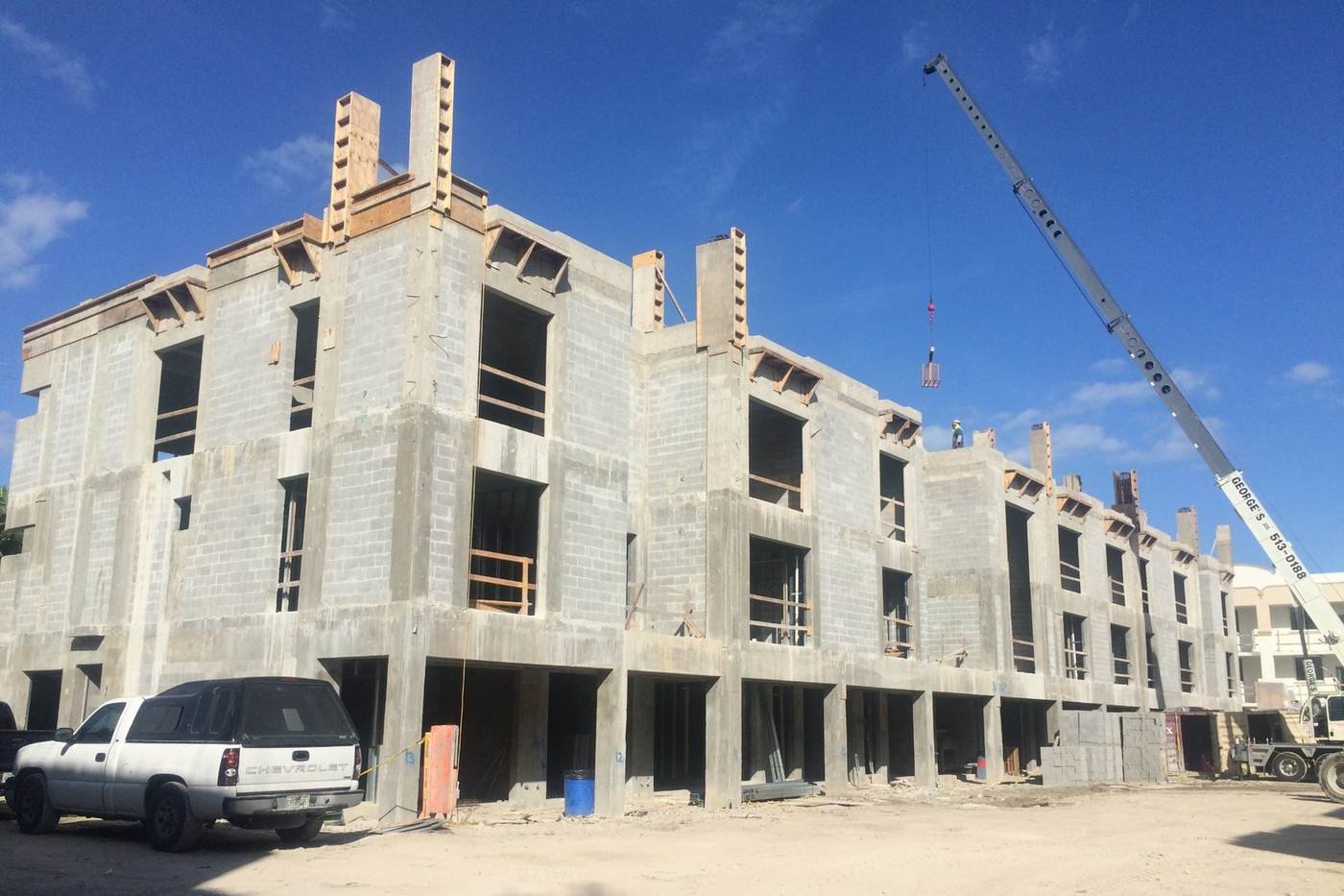 Multistory shell construction project with crew on site